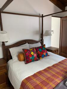 a bedroom with a bed with pillows and two lamps at Casa Anabel in Antigua Guatemala