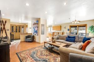 a living room with a couch and a table at Twenty Grand Chalet in Silverthorne