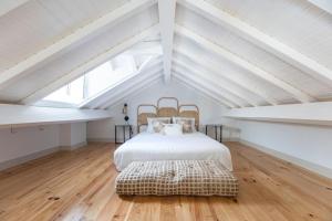 En eller flere senge i et værelse på São Bento Premium Loft - With Air Conditioning