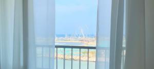 a window with a view of the ocean and a ferris wheel at Hotel Laika in Rimini