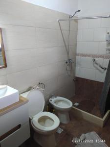 a bathroom with a toilet and a sink and a shower at El Repecho in Piriápolis +30 photos