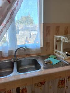 a kitchen counter with a sink and a window at Kazkreole in Mont Blanc