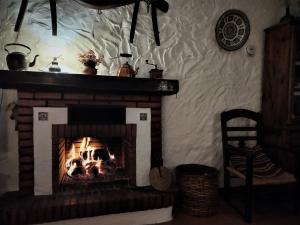 a fireplace in a living room with a fire place at Casa El Barbero 1810 in Benaocaz