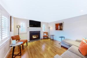 a living room with a couch and a fireplace at Chic Spacious Home Half a Mile From Commercial Street in Provincetown