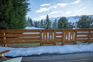 une clôture en bois avec de la neige sur une terrasse dans l'établissement Belvedere 3 ski-in ski-out, à Méribel