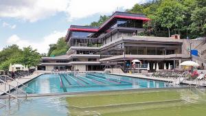 a large swimming pool in front of a building at Apartmán Víšek in Jáchymov