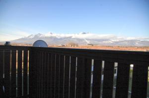 a balcony with a view of snow covered mountains at Apartment Vila Aston in Veľká Lomnica +17 photos