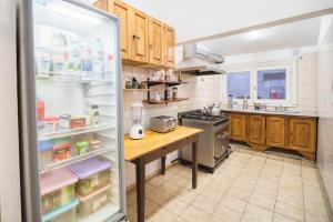 a kitchen with a refrigerator with its door open at Hostel BILL & BILL in Mar del Plata