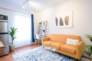 a living room with a couch and a table at 69-5D Modern Lower East East 1br Apt BRAND NEW in New York