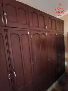 a set of wooden cabinets in a room at Namaste Hostel in Tarija