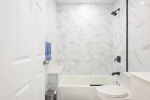 纽约240-6 NEW STUDIO Prime Location W&D in unit的带马桶和淋浴的白色浴室