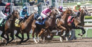 eine Gruppe Jockeys, die auf einer Rennstrecke reiten in der Unterkunft The Hamilton - Lakefront & Studio Suites, Hot Springs in Hot Springs