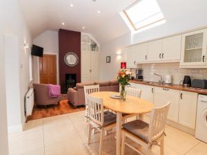 a kitchen and living room with a table and chairs at Laharn Cottage in Killorglin