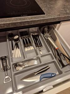 a drawer filled with utensils in a kitchen counter at Parko nauji apartamentai in Panevėžys