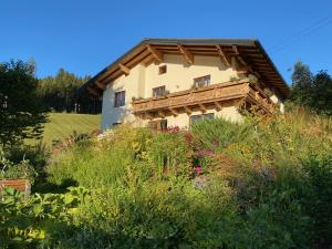 a house on a hill with a garden at Oberleiten Apartments in Wagrain