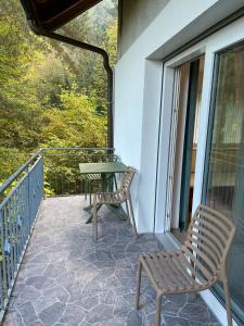 a patio with two chairs and a table on a balcony at Auf der Alm 21 N.5 in Baden-Baden