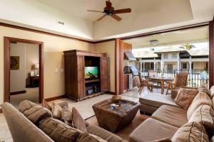 a living room with a couch and a tv at Hilton Pool Pass Included, Kolea - Luxe Penthouse in Waikoloa