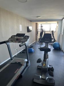 a gym with several tread machines in a room at Amazing Studio in San Telmo with River view in Buenos Aires