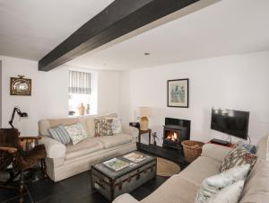 a living room with a couch and a fireplace at Bryn Tegid in Beaumaris