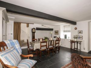a living room with a dining room table and chairs at Bryn Tegid in Beaumaris