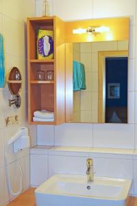 a bathroom with a sink and a mirror at Löwenhof in Krumbach