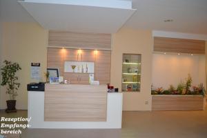 a pharmacyacist with a counter in a room at City-Hotel Cottbus in Cottbus