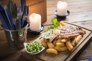 a plate of food with a sandwich and french fries at The Old Success Inn in Sennen Cove