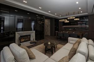 a living room with a couch and a fireplace at Cristal Garden Chalet in Bukovel