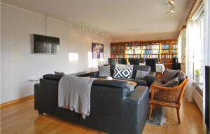 a living room with a black leather couch at Lovely Home In Borgholm With Sauna in Borgholm