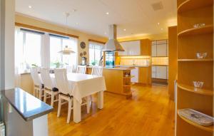 uma cozinha e sala de jantar com uma mesa branca e cadeiras em Lovely Home In Borgholm With Sauna em Borgholm