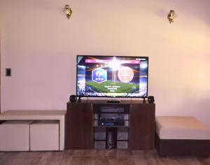 a flat screen tv sitting in a living room at NUESTRA CASA EN CHACRAS DE CORIA (Bª PRIVADO) in Chacras de Coria