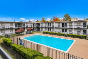 a swimming pool in front of a building at Red Roof Inn Knoxville North - Merchants Drive in Knoxville