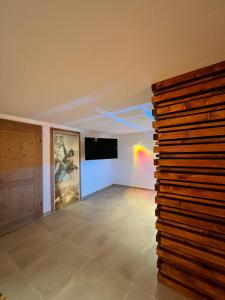 A television and/or entertainment centre at Alm'a Residence