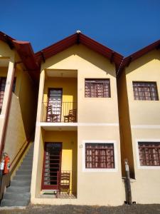 a building with stairs in front of it at Chalé da Montanha in Serra Negra