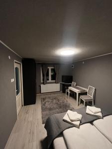 a bedroom with a bed and a table and chairs at Casa de vacanță Cheșa in Borsec
