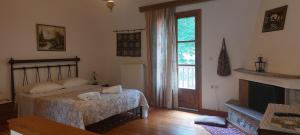 a bedroom with a bed and a fireplace at Andrea Sofi Guesthouse in Dimitsana
