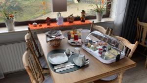 a table with a tray of food on it at Pension Harzkieker in Altenau +17 photos