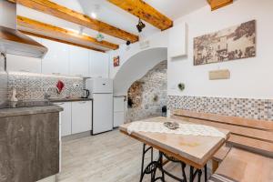 a kitchen and dining room with a table and chairs at Apartment VOLTE in Punat