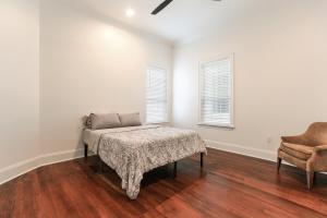 a living room with a table and a chair at Canal Street Mini Mansion Sleeps 15 in New Orleans