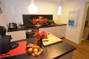 a kitchen with a counter top with a bowl of fruit at Kleine Villa in Trier
