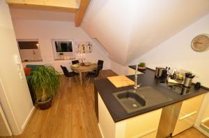 a kitchen with a sink and a table in a room at Kleine Villa in Trier