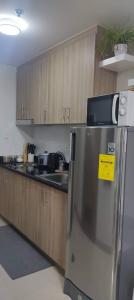 a kitchen with a refrigerator with a yellow sign on it at Your home in the city in Manila