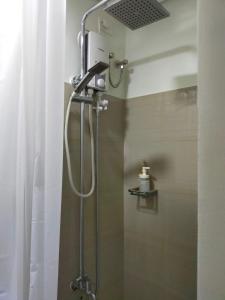 a shower with a shower head in a bathroom at Your home in the city in Manila