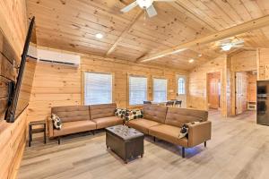 a living room with two couches and a flat screen tv at Laurelville Cabin Less Than 11 Mi to Old Mans Cave! in Laurelville