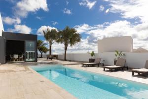 a villa with a swimming pool and a patio at Villa Serenity in Tías