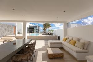 a living room with a couch and a table at Villa Serenity in Tías