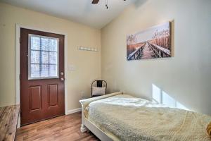 een slaapkamer met een bed, een raam en een deur bij Gray Home with View of Boone Lake and Fire Pit! 