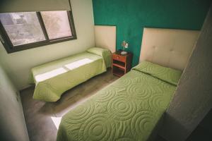 a small bedroom with two beds and a window at lacasonavistalago in Villa Carlos Paz