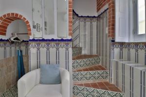 salon z białą kanapą i schodami w obiekcie Zenit charm Olhao relax cubist House w mieście Olhão