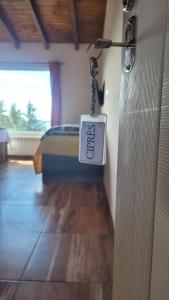 a door with a tag hanging from a room with a bed at Astrolabio Hostel in San Carlos de Bariloche
